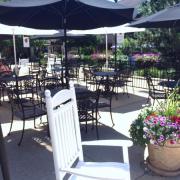 Photo of tables & chairs on patio outside Kilwins Geneva